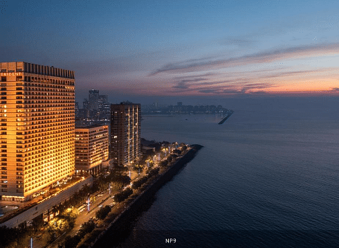 Trident Nariman Point hotel in Mumbai stands tall at sunset, overlooking the Arabian Sea.