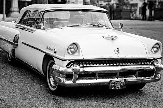 Front view of a white vintage Mercury Monterey classic car with chrome detailing.