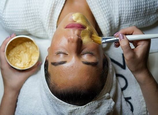 An image of a person having a face mask applied.