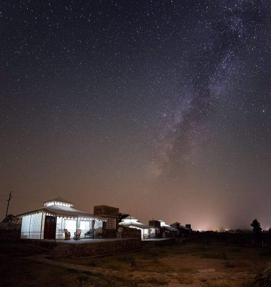 A facade image of the Utsav Camp Sariska which is brightly lit
