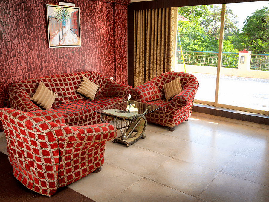 Adamo Resort Matheran - Royal Suite living area featuring sofas and a big widow