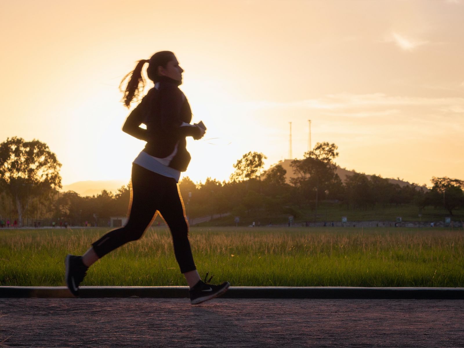 A woman jogging at sunset