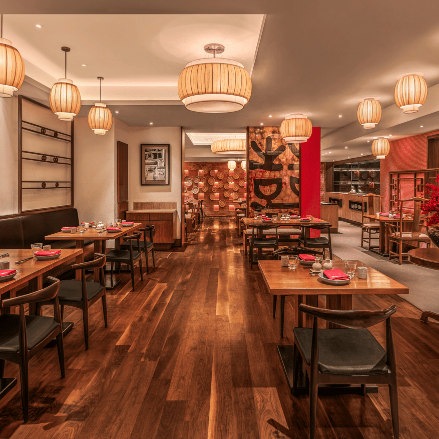 Indoor restaurant with wooden flooring and dining tables at The Raintree, St. Mary’s Road.