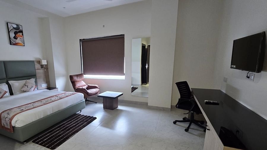 Premium Room in Clarks Inn Express, Firozabad, featuring a double bed, lounge chair, a work desk, and a wall mounted flat screen T.V.