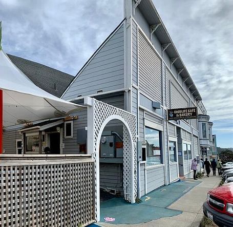 A building with a white awning and a sign for Good Life Cafe & Bakery