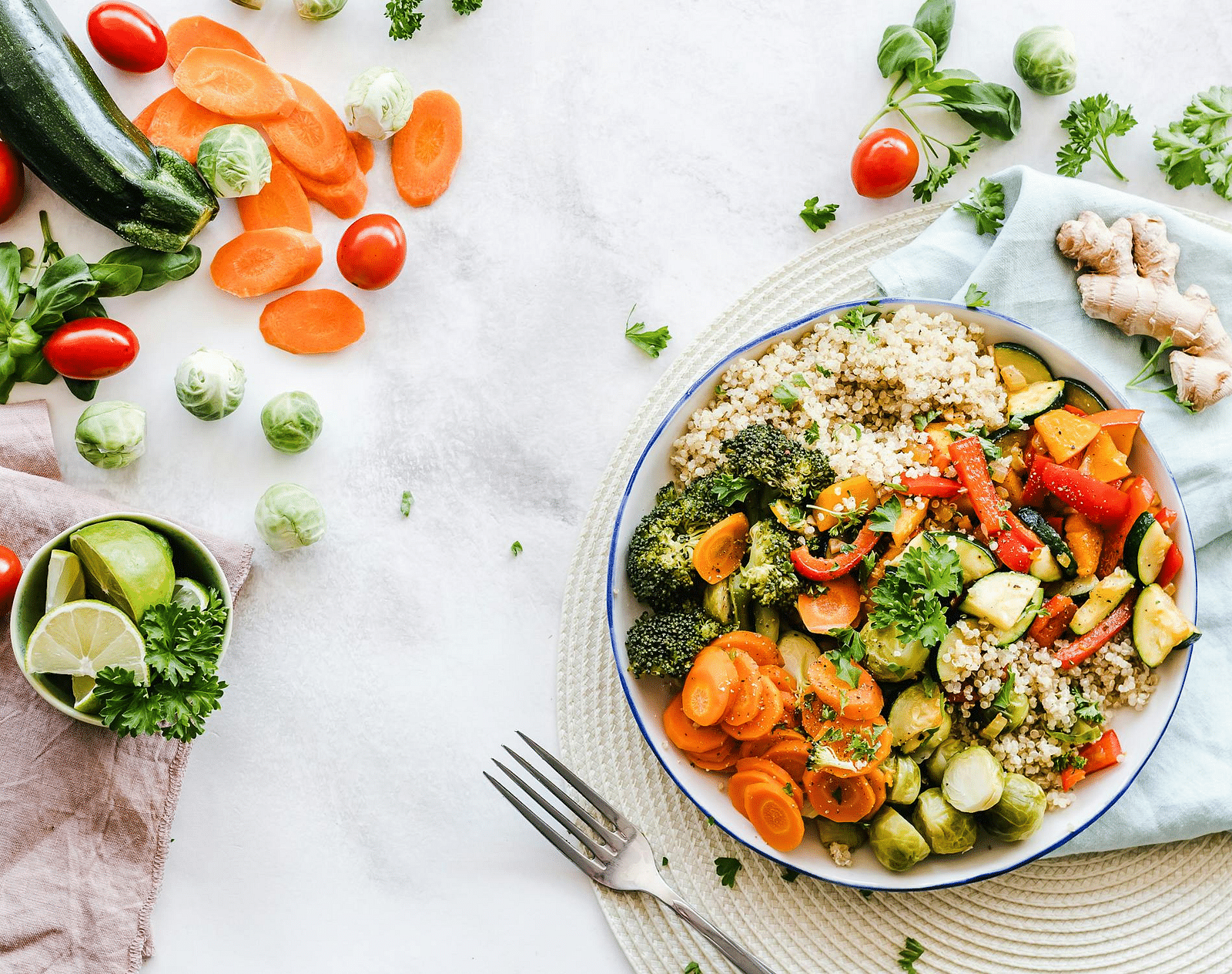 A vibrant salad bowl filled with fresh vegetables, including tomatoes, cucumbers, carrots, and greens, placed on a bright table.