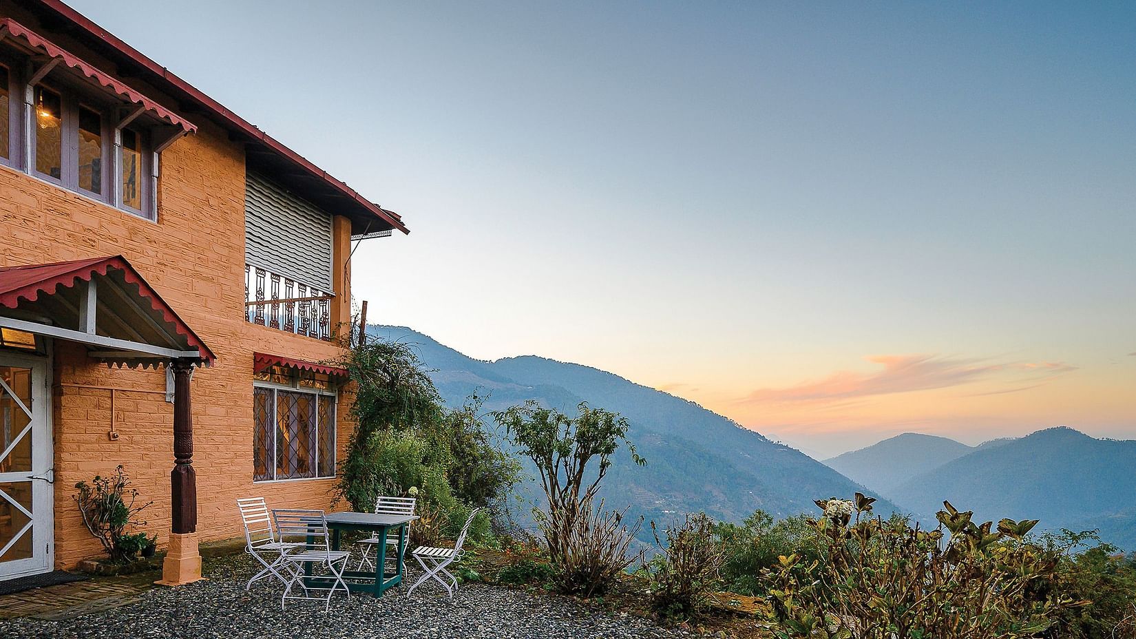 Cottage on a hill with the backdrop of lush mountains at The Ramgarh Bungalows - 19th Century, Above Nainital.