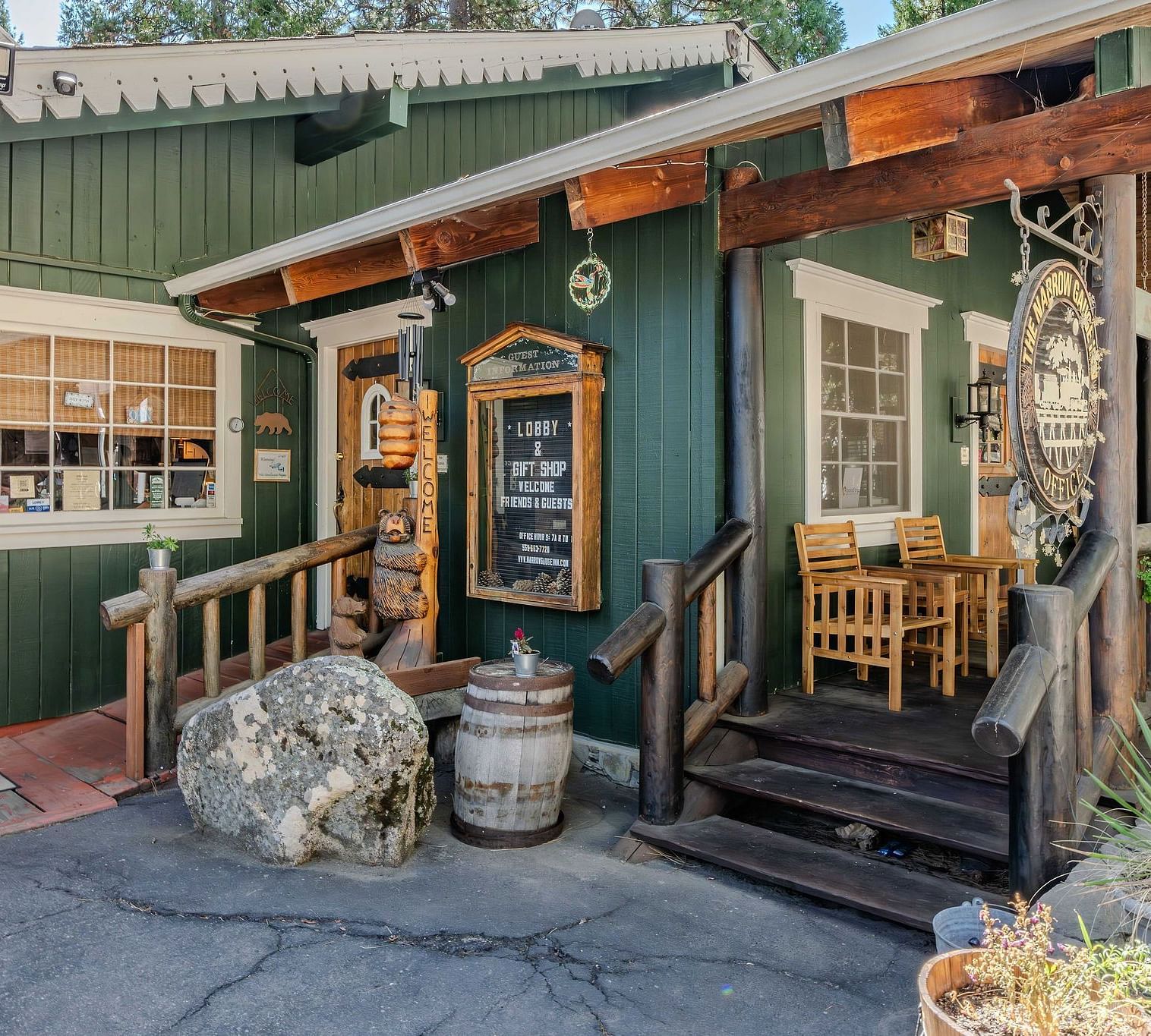 A view of a wooden cabin with pastel green exteriors at Narrow Gauge Inn
