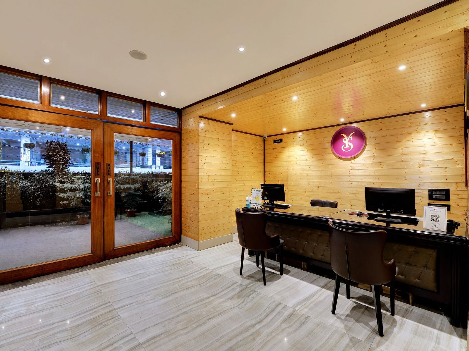 Reception area of Sumitel Shangrila with desk and chairs and bright lighting