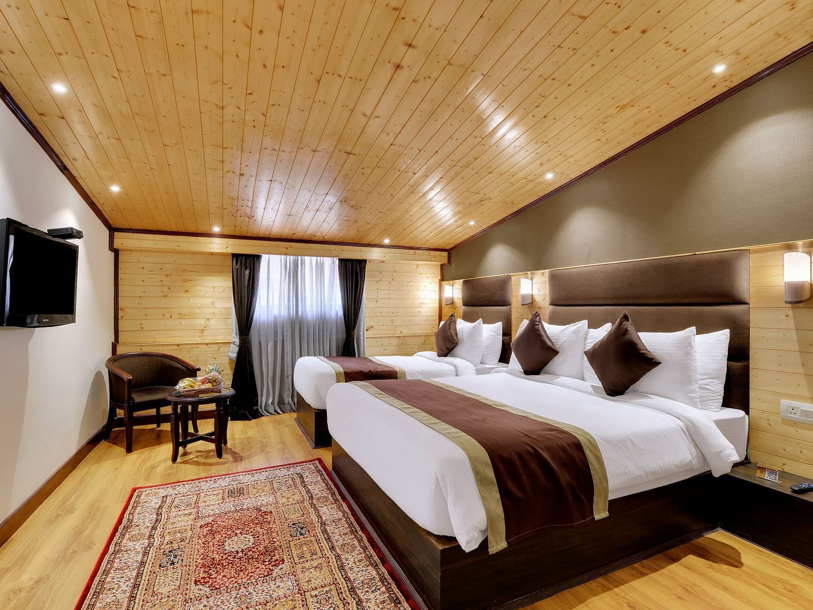 Image of a room with two large beds and a television in front-Sumitel Shangrila, Deorali