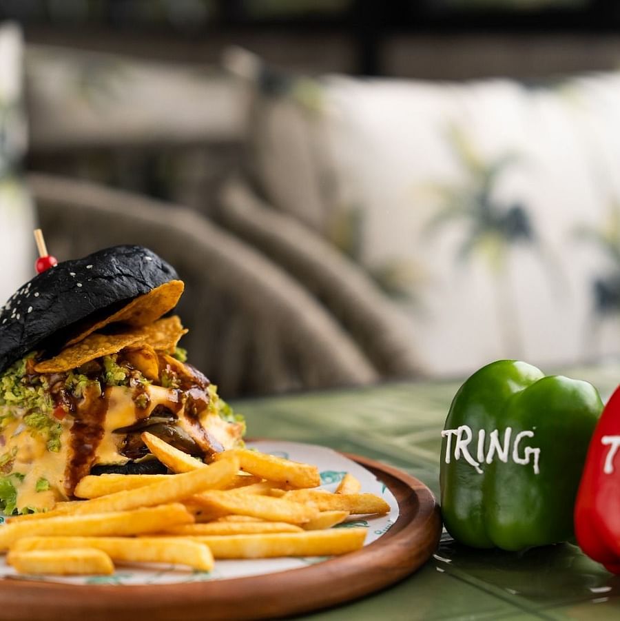 alt-text An image of a wooden plate with a burger, French fries, and two capsicums, each labelled Tring.