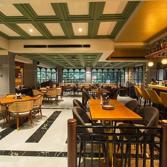 An image of Tring Tring Restaurant and Bar at Hotel Polo Towers, Shillong, featuring decorated tables, ambient lighting, and a bar counter.