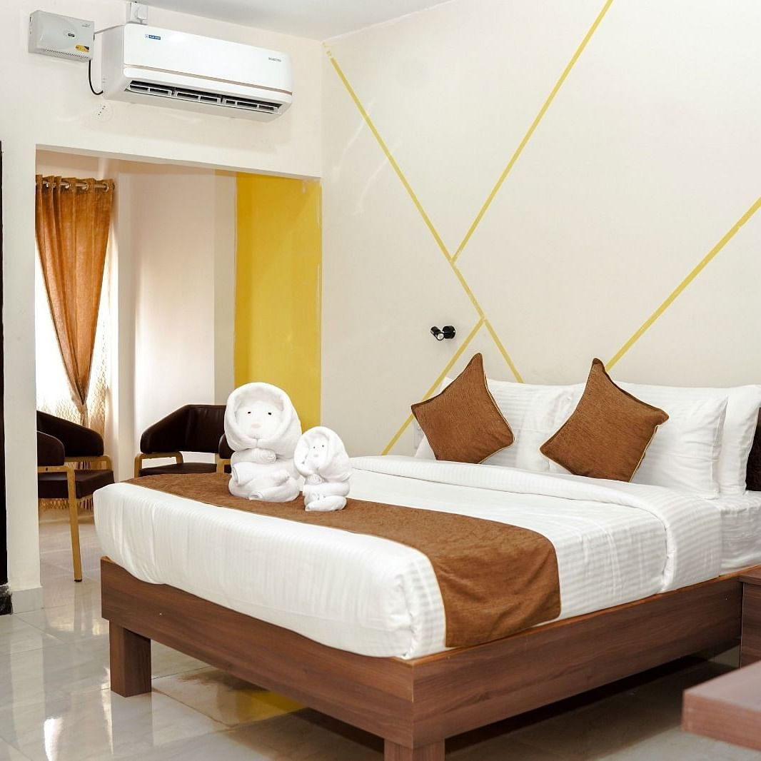 A well-lit room with a double bed at ANS M Square Hotel & Resort, Kalaburagi