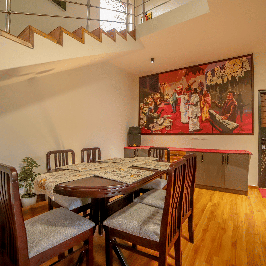 A large wooden table placed in the dining area with wooden flooring at MYST Resorts, Doddabetta, Ooty.