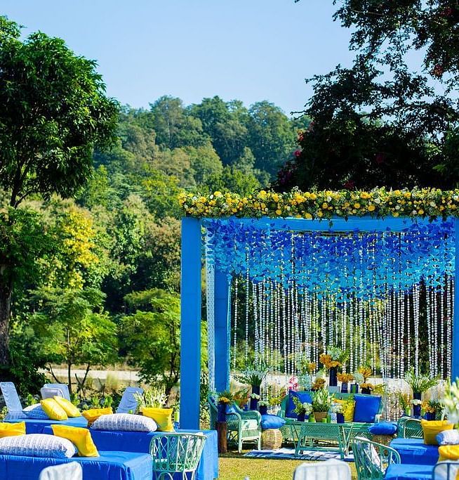 Seating arrangements for a wedding set up decorated with flowers in an open garden