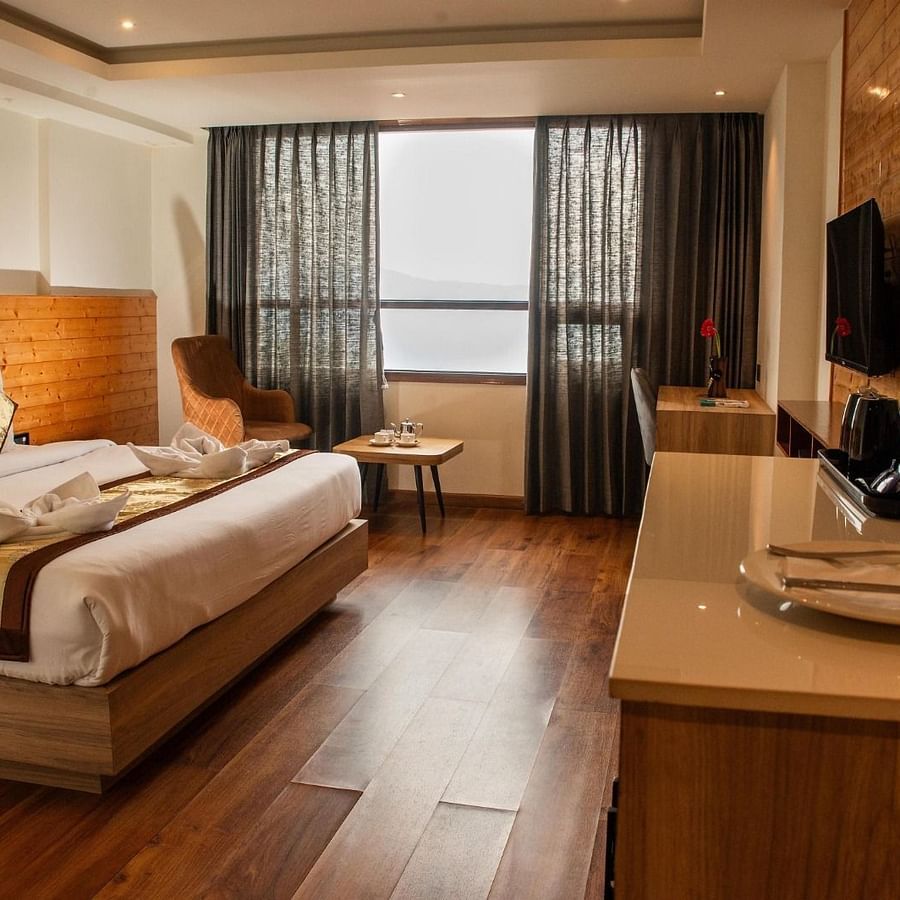A bedroom featuring a double bed along with a wall mounted television in front of it - Sumitel Sanderling