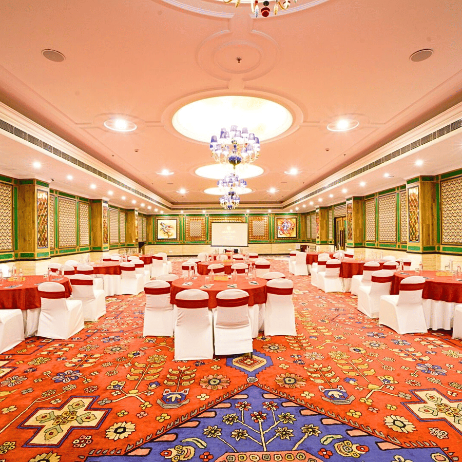 Elegantly decorated Orchid banquet hall with round tables at MAYFAIR Oasis Resort and Convention Jharsuguda