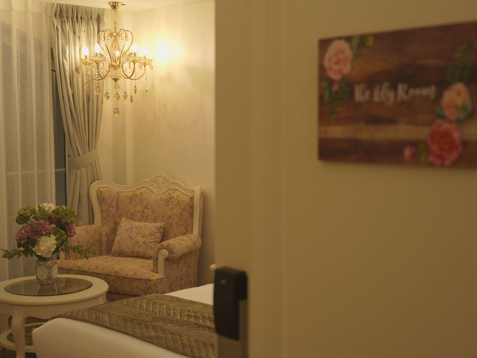 Cosy seating corner with armchairs, a round table, and floral decor - Mayfair Cafe & Suites, Dalhousie