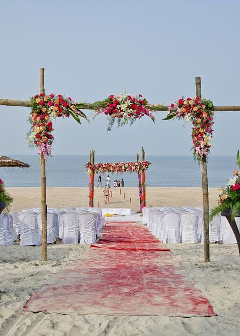 outdoor wedding setup on the beach with the ocean in the background
