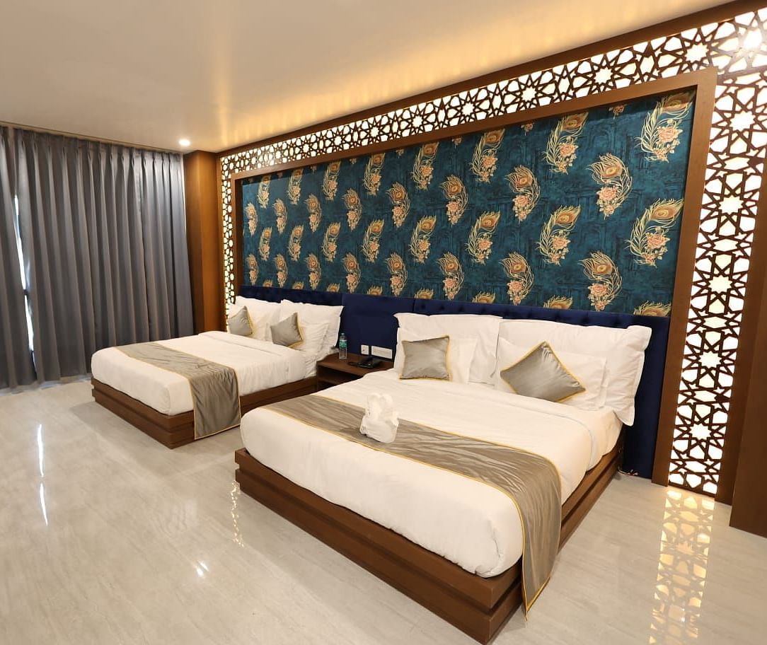 An interior shot of a room with twin beds and a textured accent wall - Bamboo Saa Mulberry Resort, Pushkar
