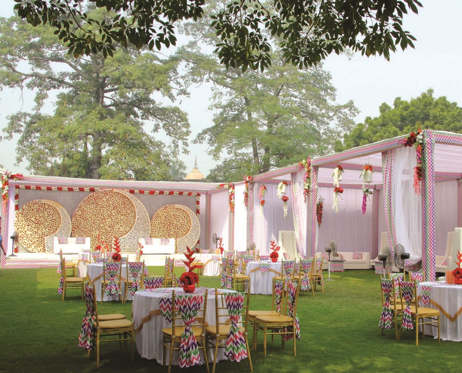 Outdoor wedding setup with round tables and floral decor | Gemini Continental