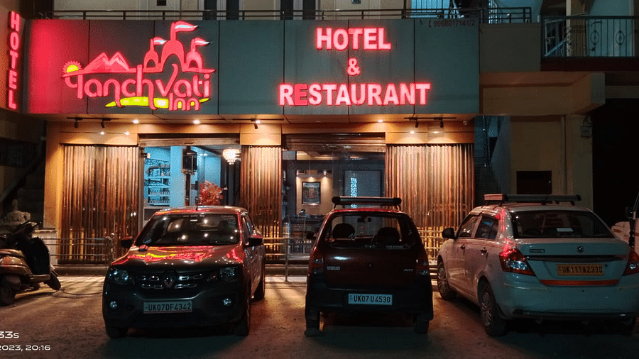 Facade of Hotel Panchvati Inn with cars parked outside