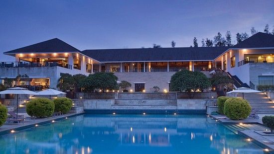 an image of the exterior facade of The Serai Chikmagalur in the evening