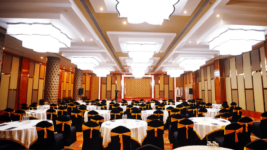 Full view of the Mrighashira banquet hall decorated for an event in round-table seating configuration at Leroy Grand, Yeshwanthpur.
