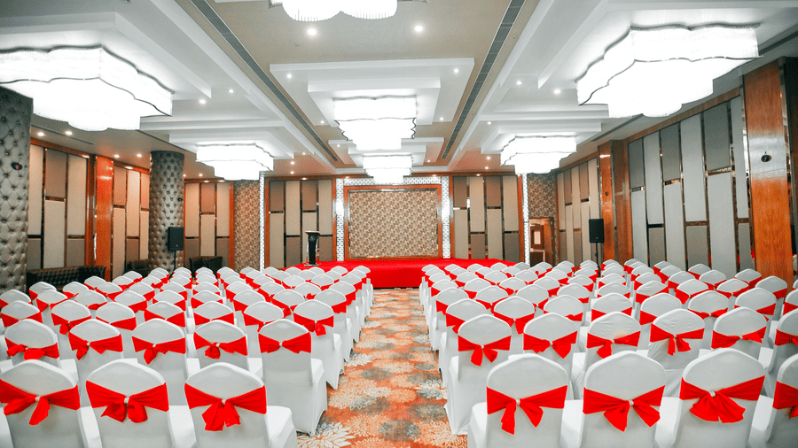A panoramic shot of the Mrighashira banquet hall with chairs facing towards the stage, arranged in a theatre setting at Leroy Grand, Yeshwanthpur.