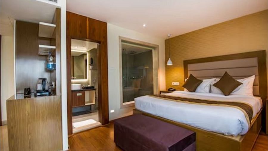 Image of a room at Yashshree The Imperial Inn siliguri with a bed, a purple table and other ameneties 