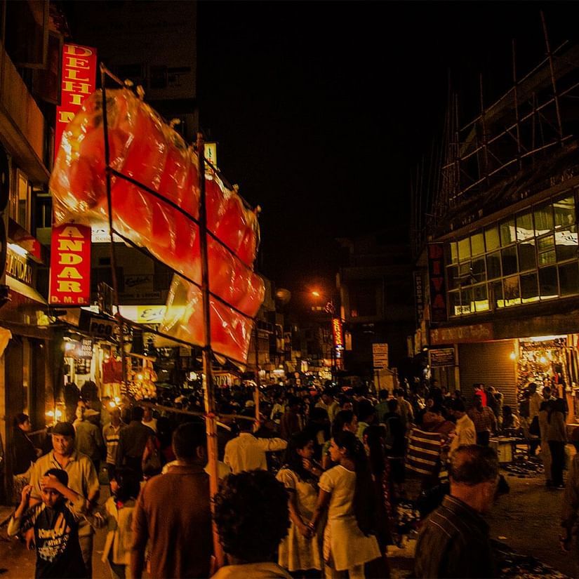 a crowd of people walking in a bazaar