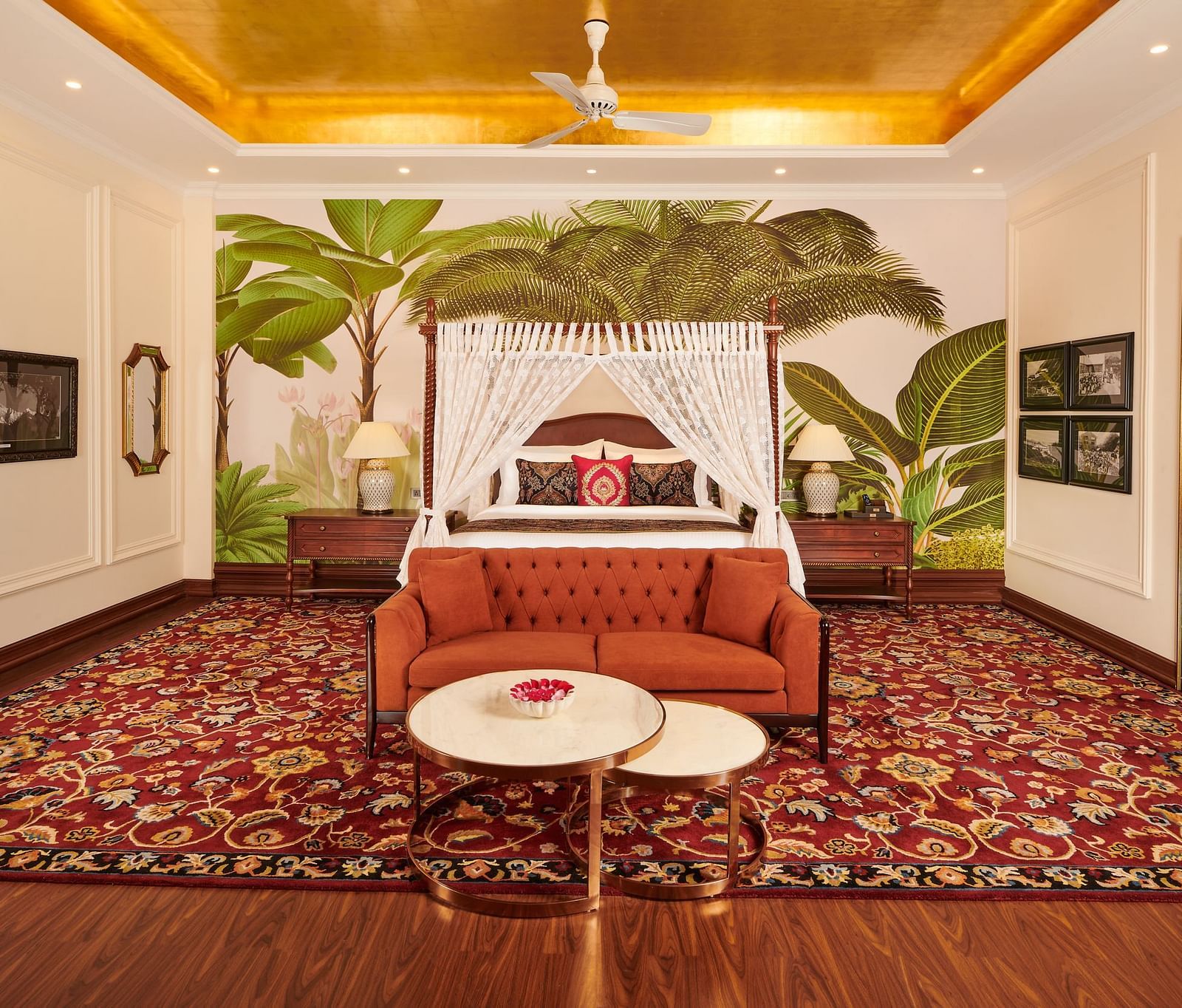 Spacious room with vintage-style canopy bed and tropical wall art.