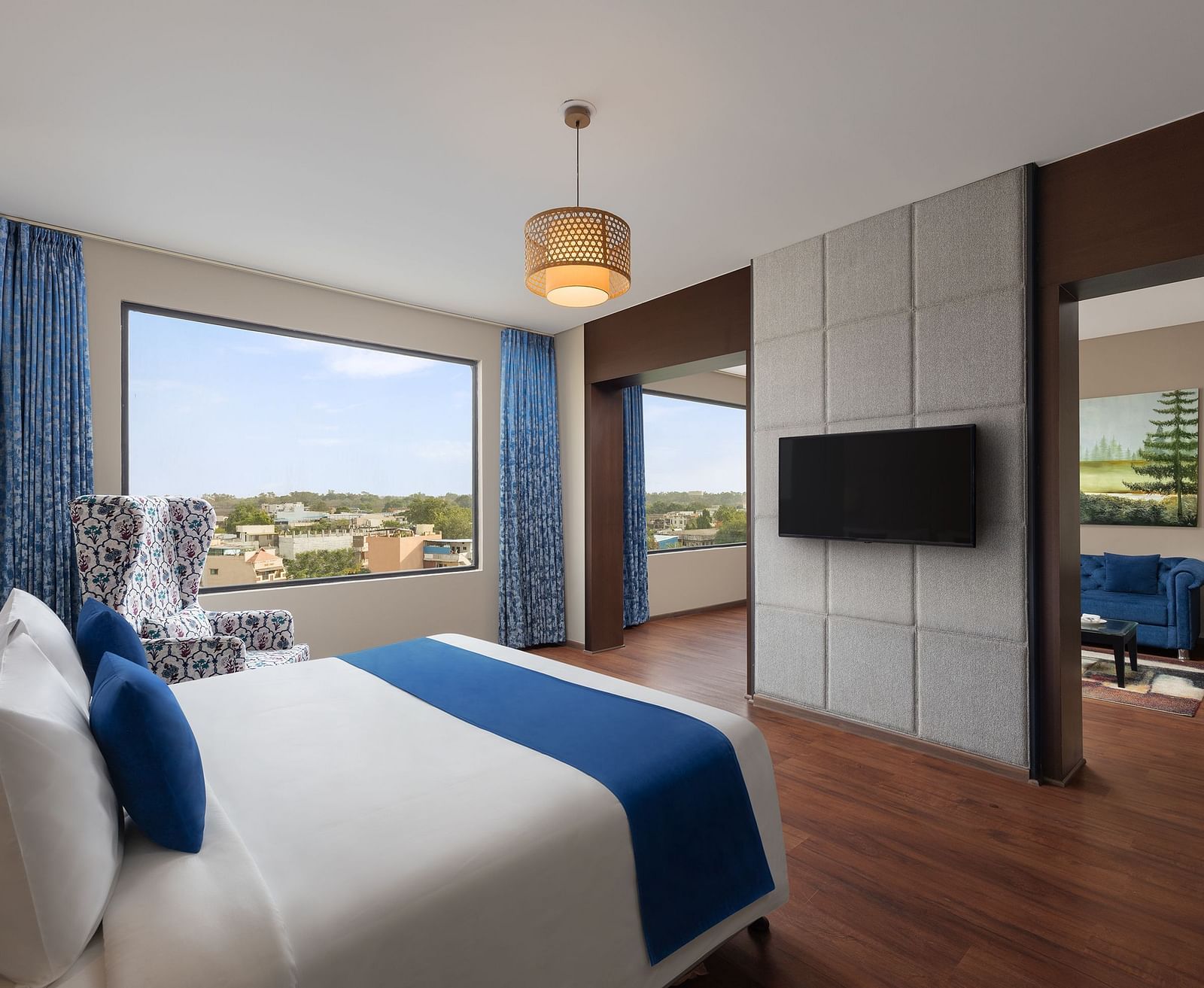 Dleuxe Suite at Essentia Luxury Hotel, Indore with a double bed, a television and a separate living area