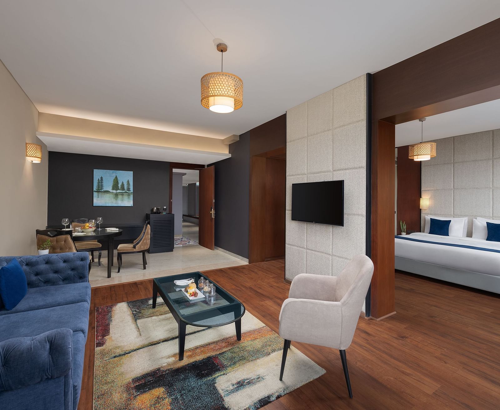 Living room area of Execuitve Suite at Essentia Luxury Hotel, Indore with sofa seating and coffee table set up.