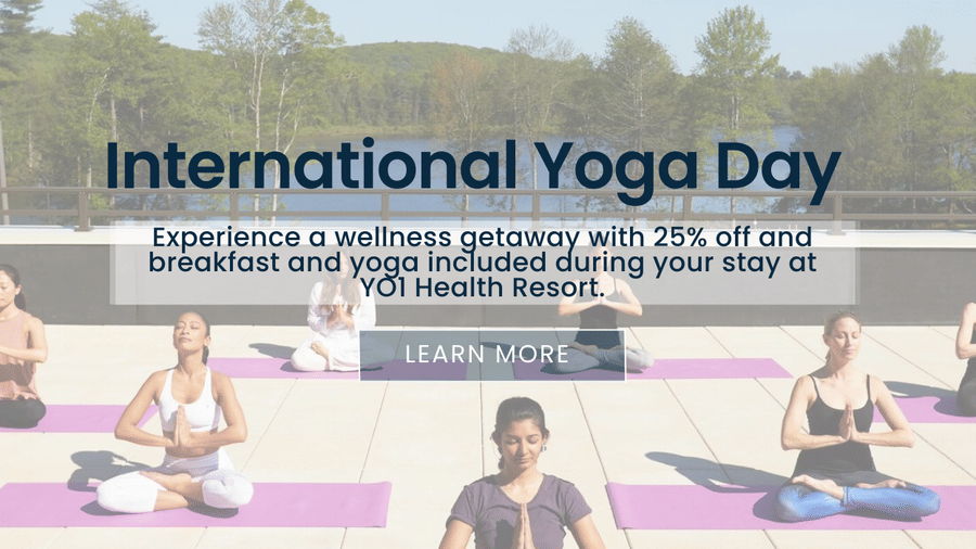 Banner for International Yoga Day at YO1 Longevity & Health Resorts, featuring participants practicing yoga outdoors with text inviting guests to embrace wellness and balance during their stay
