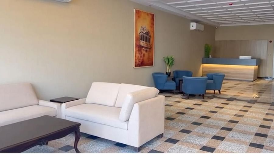 A spacious reception area at Urban Suites by BluSalzz, Jaipur, featuring cushioned sofas, tables, and warm lighting for a welcoming ambience.
