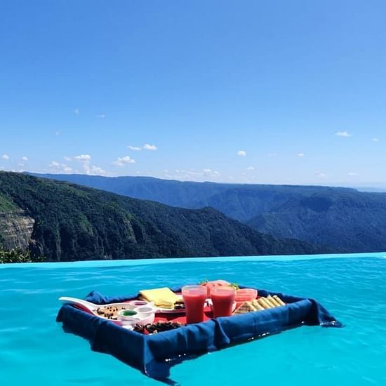 the view of a board with food on it at our infinity pool in Cherrapunjee
