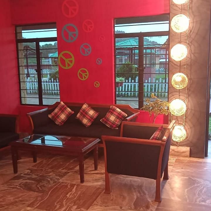 A living room with sofas and red walls