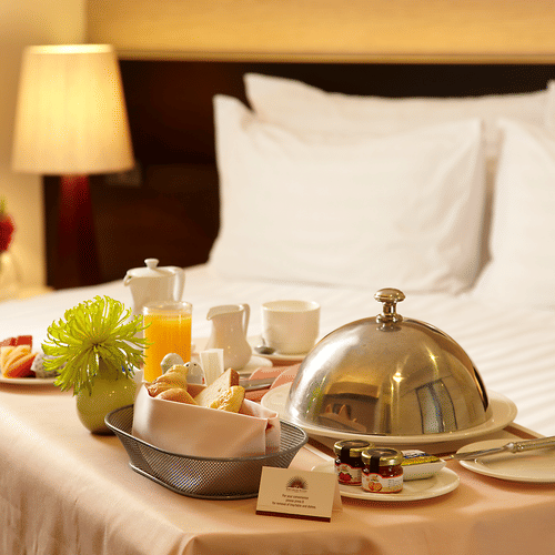 a bedside table containing breakfast