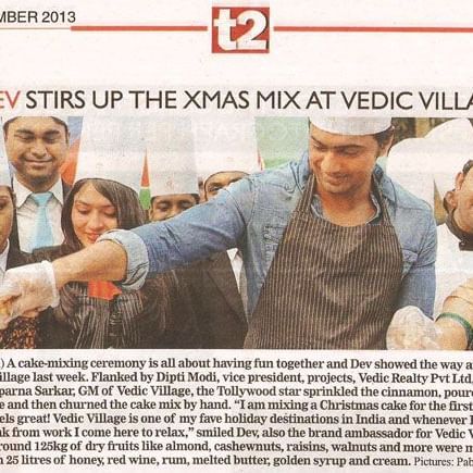 A newspaper page titled F&B showing a group of people enjoying and serving food at the Xmas Mix at Vedic Village Spa Resort.