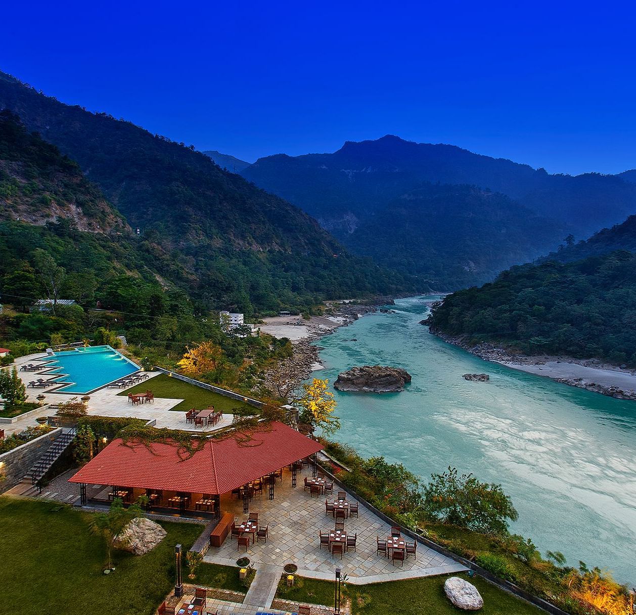 Aerial view aloha on the ganges, with the river flowing on the side and mountains in the background