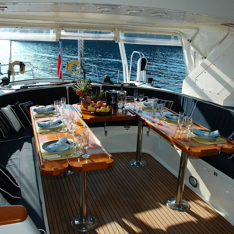 food tables set up inside a boat cruise with the ocean seen through the windows