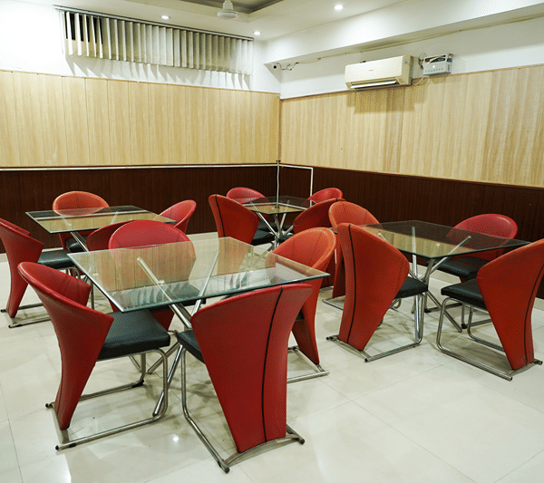 Lime Tree Banquet Hall set with red chairs and glass-topped tables.