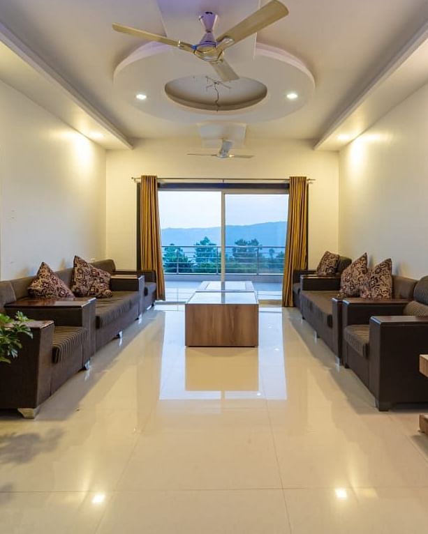 A hotel lobby with seating areas and a view to the outside.
