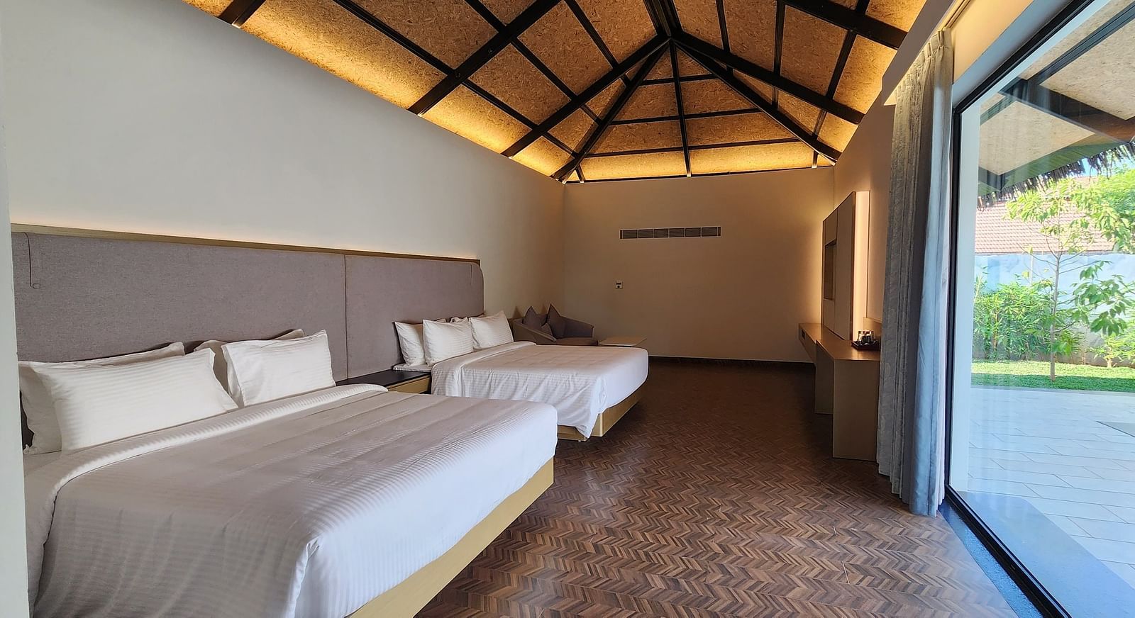 Corner view shot of the Exotic Pool Villa with the roof lined with yellow lighting at The Shore, Trishvam.