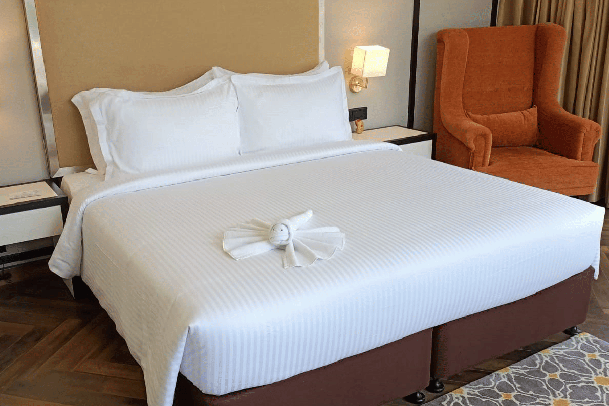 guestroom-king-bed-orange-armchair
