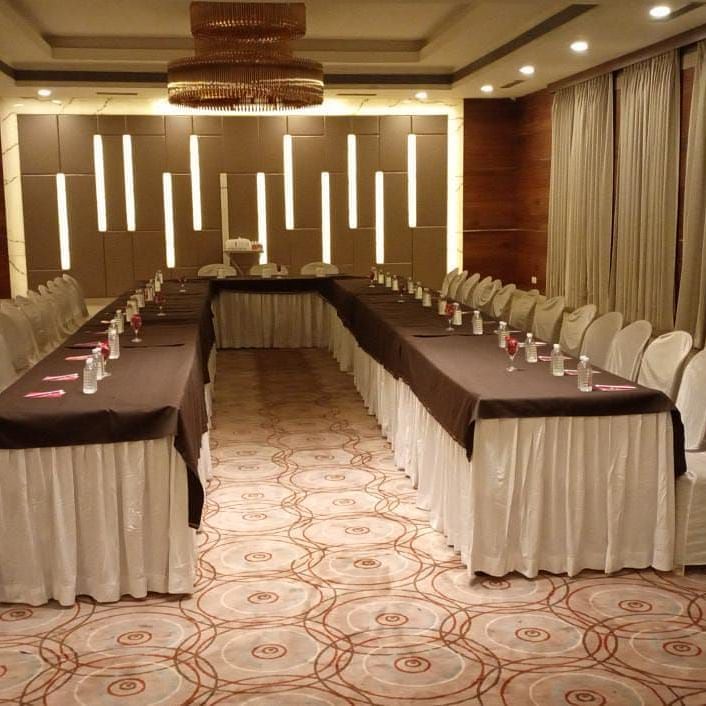 A formal meeting room with modern interiors at Rang Lords Inn, with a u-shape seating arrangement