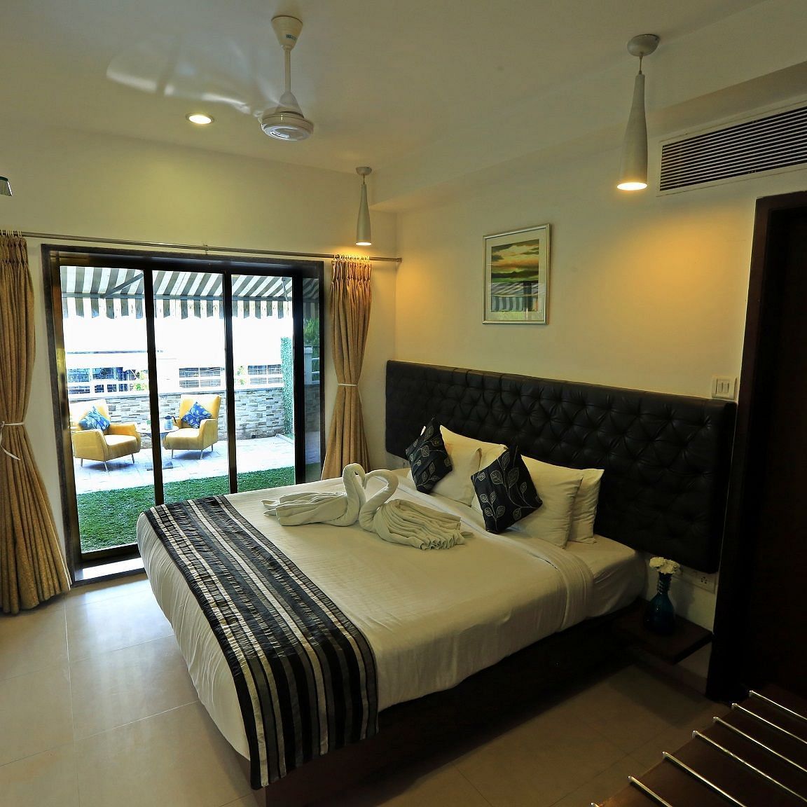 Premuim Garden Terrace Room with bed and large windows at The Oriental Residency