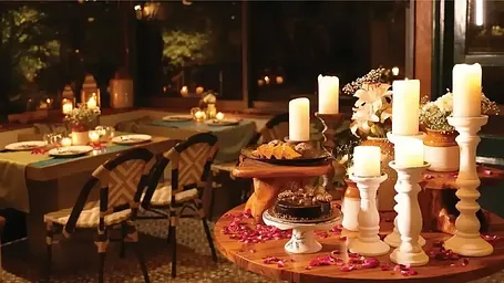 Dining area with candle lit tables and chairs.