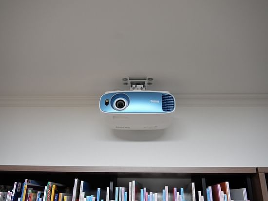 A blue coloured wall mounted projector in our meeting hall - Stone Wood Nature Resort, Gokarna